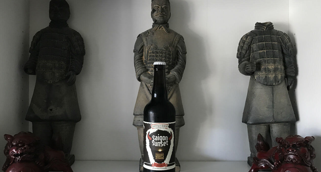 beer-chronicle-houston-craft-beer-review-saigon-sunset-beer-placed-in-front-of-statues