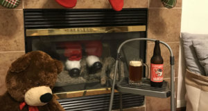 beer-chronicle-houston-craft-beer-review-sailing-santa-beer-in-glass-next-to-chimney-with-santa's-legs-hanging-out