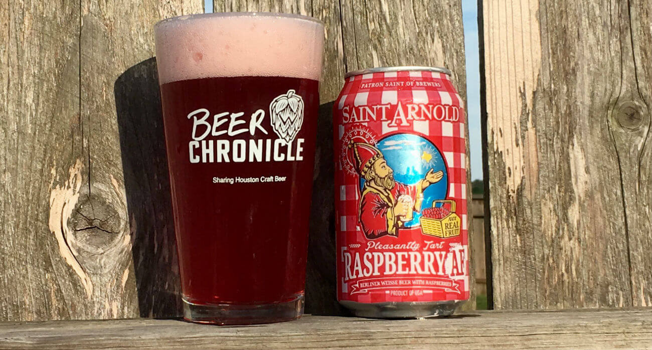 Beer-Chronicle-Houston-Craft-Beer-Review-Saint-Arnold-Raspberry-AF-Full-Pint-Glass-Next-To-Can-On-Fence