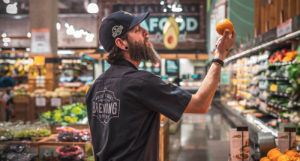 Beer-Chronicle-Houston-whole-foods-brewing-whole-foods-brewing-josh-olalde-james-looking-at-orange
