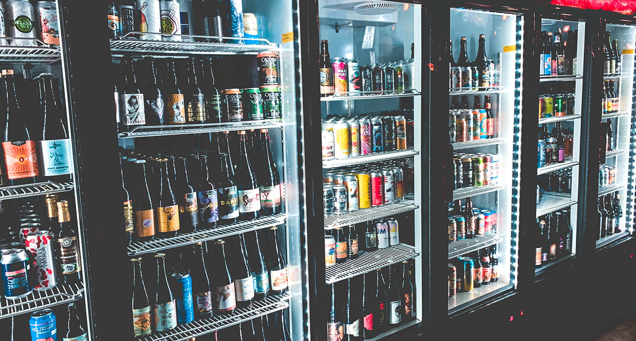 diverse-beer-cooler-well-lit-displaying-colorful-bottles-and-cans-beer-chronicle-houston-best-beer-bars-to-visit-in-houston_0002_justin-sanchez-PoAC9dCnofk-unsplash